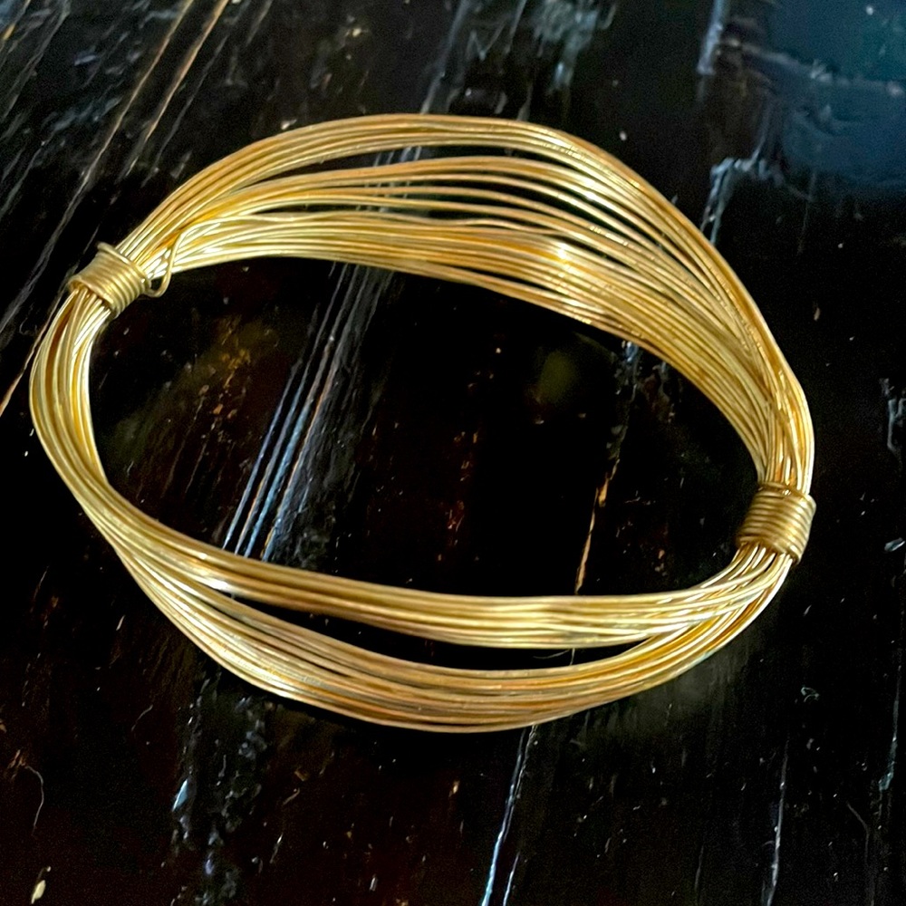 Gold multi string metal bracelet